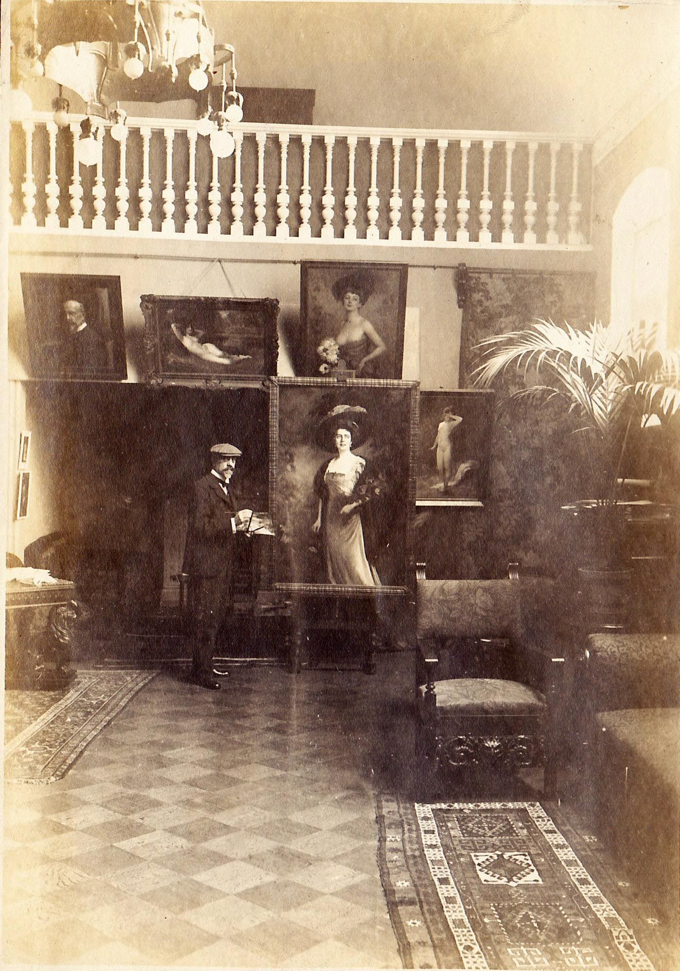 This photo is of the artist Stember in his studio surrounded by completed paintings. They can be see