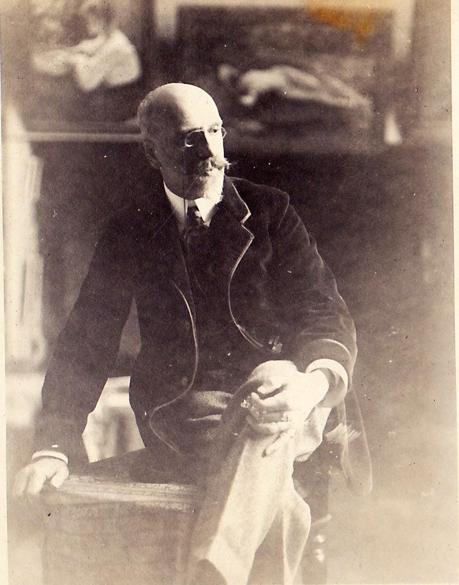 Stember in his studio. Behind him are two paintings on this site: #150 'A Letter' and #233 which is